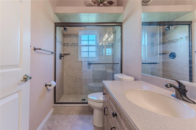 bathroom with toilet, vanity, tile patterned floors, and a shower with door