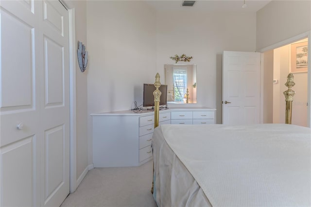 bedroom featuring light carpet