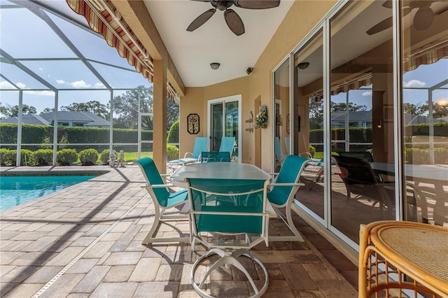 sunroom / solarium with a swimming pool and ceiling fan