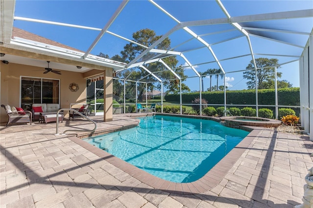 view of swimming pool featuring an in ground hot tub, ceiling fan, a patio, and a lanai