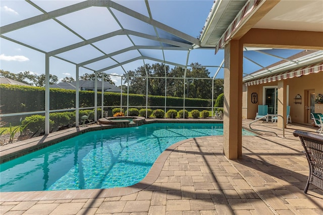 view of pool featuring a patio, an in ground hot tub, and glass enclosure