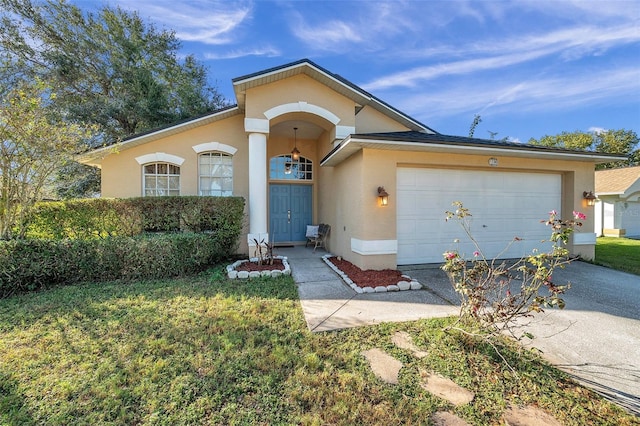 view of front of home featuring a front yard and a garage