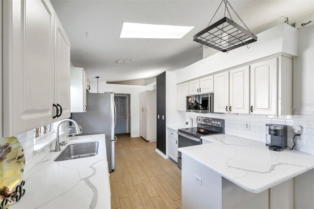 kitchen with white cabinetry, appliances with stainless steel finishes, and sink