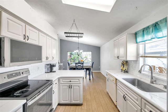 kitchen featuring white cabinetry, a healthy amount of sunlight, appliances with stainless steel finishes, and sink