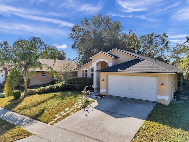 view of front of home with a front yard and a garage