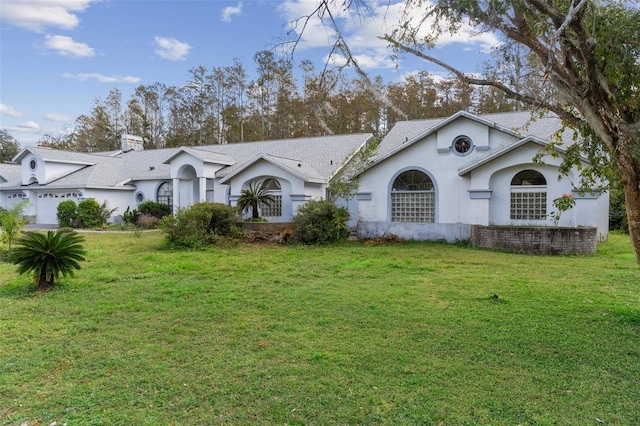 ranch-style house featuring a front yard and a garage