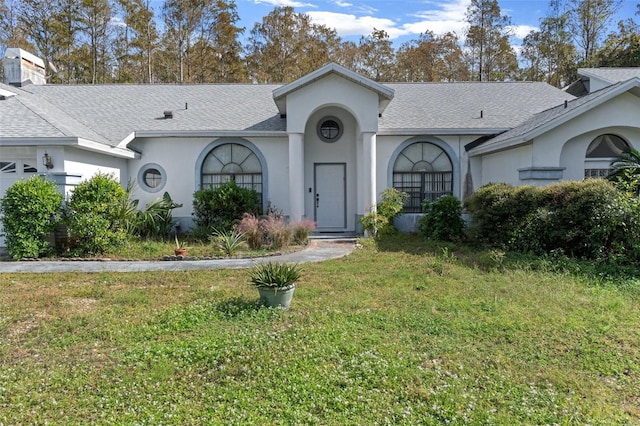 ranch-style house with a front lawn