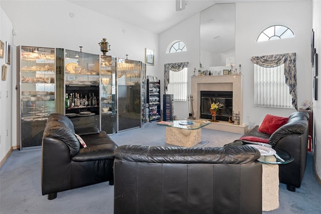 carpeted living room with high vaulted ceiling