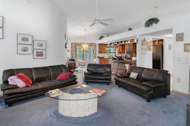 carpeted living room with ceiling fan