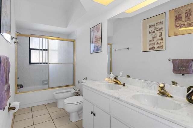 full bathroom featuring toilet, tile patterned floors, bath / shower combo with glass door, vanity, and a bidet