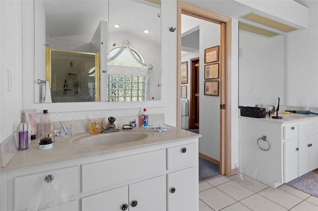 bathroom with vanity, tile patterned floors, lofted ceiling, and a shower with door