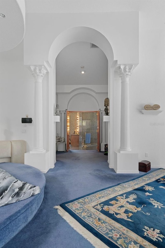 hallway featuring carpet and ornate columns