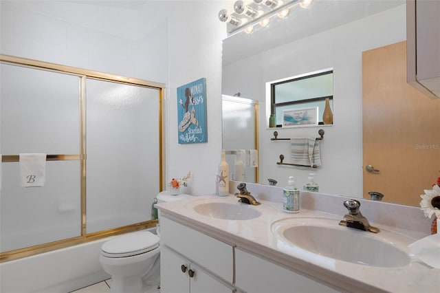 full bathroom with toilet, bath / shower combo with glass door, vanity, and tile patterned flooring