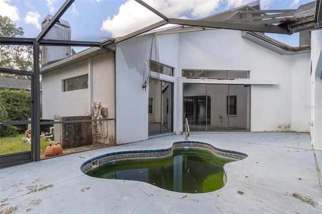 view of swimming pool with a patio and glass enclosure