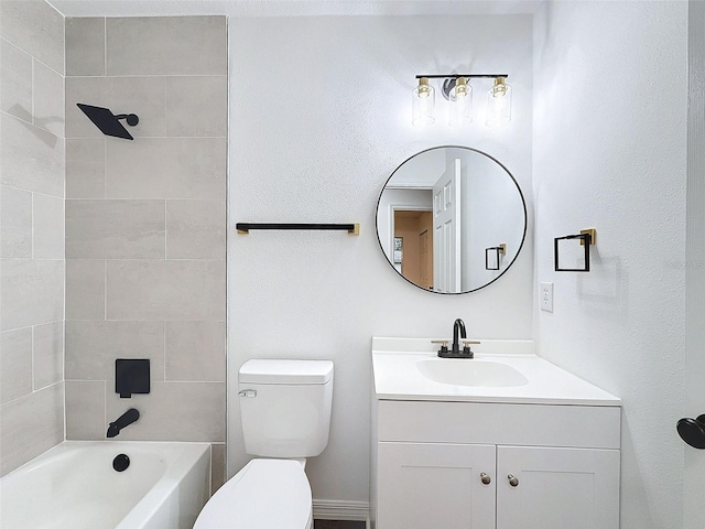 full bathroom featuring toilet, tiled shower / bath, and vanity