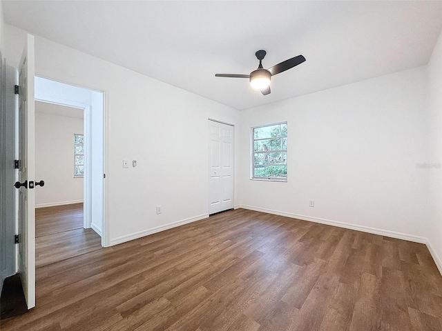 unfurnished bedroom with a closet, ceiling fan, and wood-type flooring