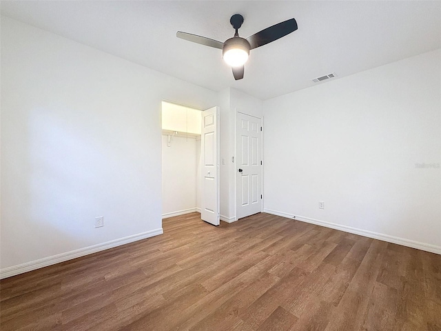 unfurnished bedroom with a closet, ceiling fan, and hardwood / wood-style floors