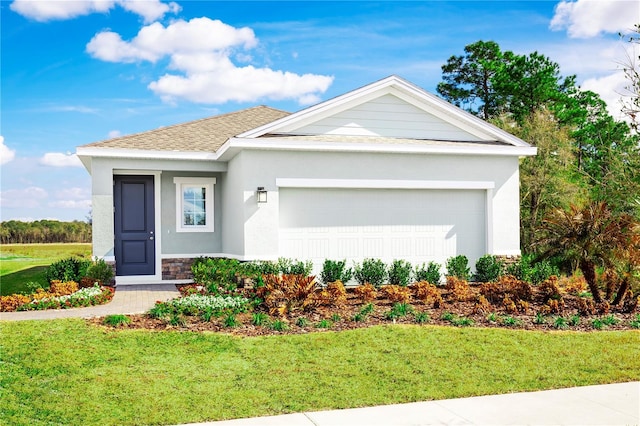 view of front of property featuring a front lawn and a garage