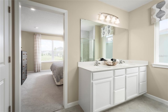 bathroom featuring vanity, tile patterned floors, walk in shower, and a textured ceiling