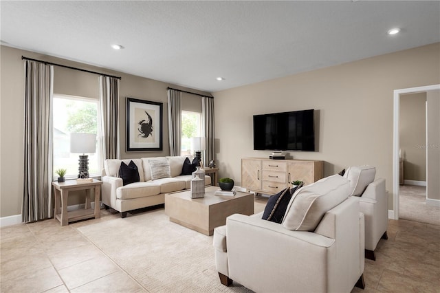 tiled living room with a wealth of natural light and a textured ceiling