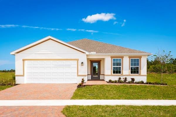 single story home with a front yard and a garage