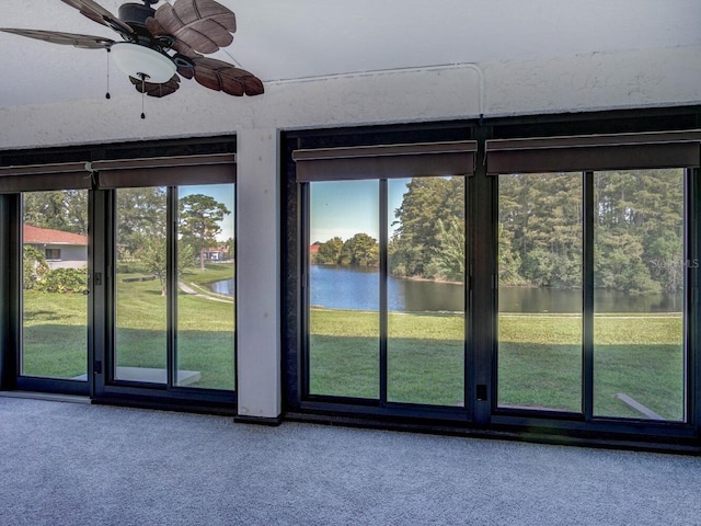 7719 Cosme Dr Unit 1, Hudson, FL 34667 - doorway featuring carpet, a water view, and ceiling fan