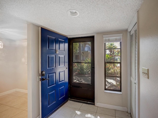 7719 Cosme Dr Unit 1, Hudson, FL 34667 - foyer entrance featuring a textured ceiling, baseboards, and light tile patterned floors