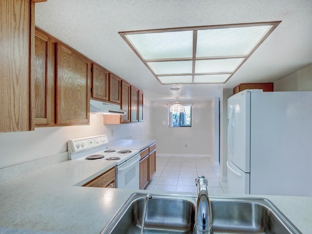 7719 Cosme Dr Unit 1, Hudson, FL 34667 - kitchen with white appliances, under cabinet range hood, a sink, light tile patterned floors, and brown cabinets