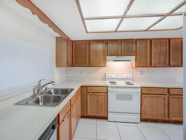 kitchen with white appliances, light tile patterned floors, a sink, light countertops, and under cabinet range hood