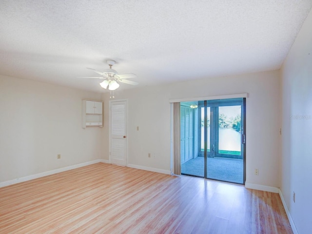 empty room with light hardwood / wood-style flooring, a textured ceiling, and ceiling fan