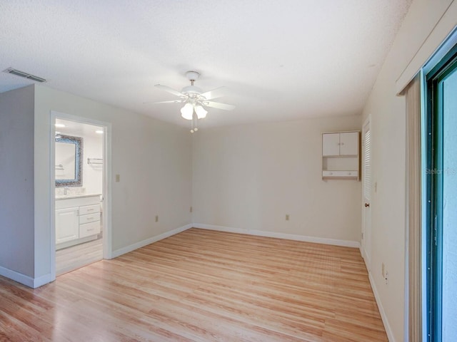 7719 Cosme Dr Unit 1, Hudson, FL 34667 - unfurnished room featuring ceiling fan, light wood finished floors, and baseboards