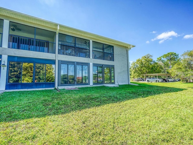 rear view of house featuring a lawn