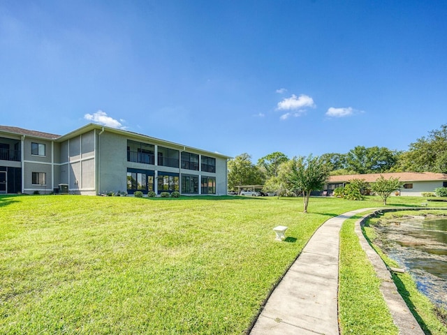 back of property with a yard and cooling unit