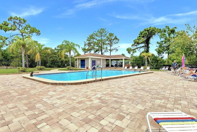 pool featuring a patio and fence