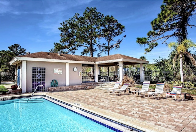 pool featuring a gazebo, a patio, and fence