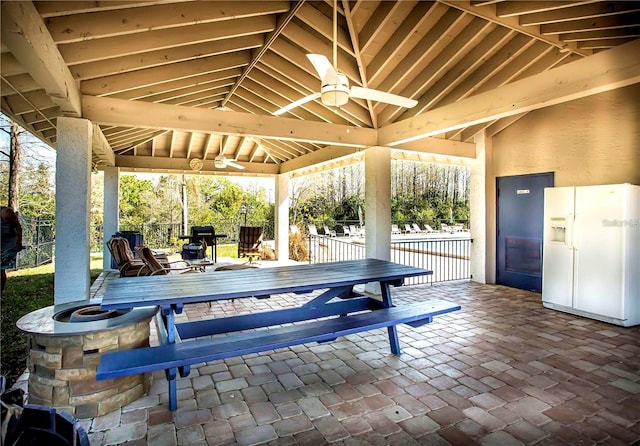 view of patio / terrace with a gazebo, outdoor dining space, a ceiling fan, and fence