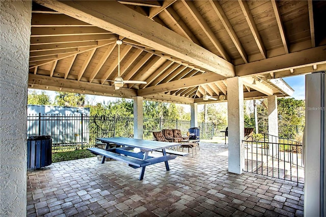 view of patio featuring a gazebo, outdoor dining area, and fence