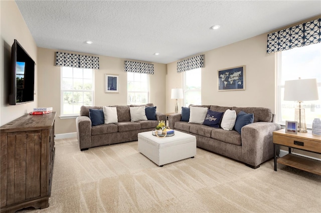 carpeted living room featuring a textured ceiling