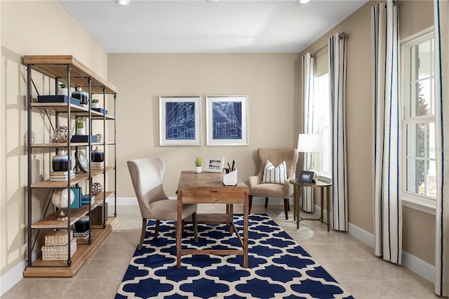 sitting room with a wealth of natural light and light tile patterned floors