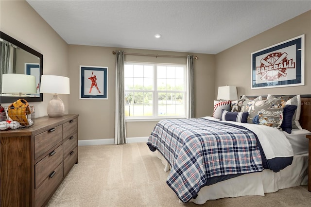 bedroom with light carpet and a textured ceiling