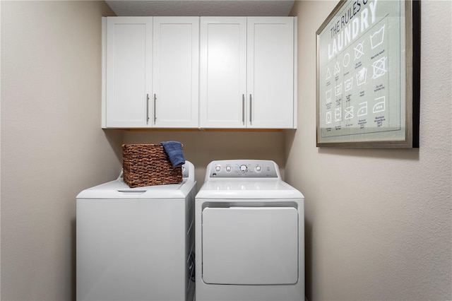 laundry room featuring independent washer and dryer and cabinets