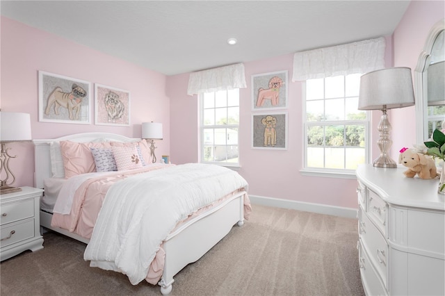 carpeted bedroom featuring multiple windows