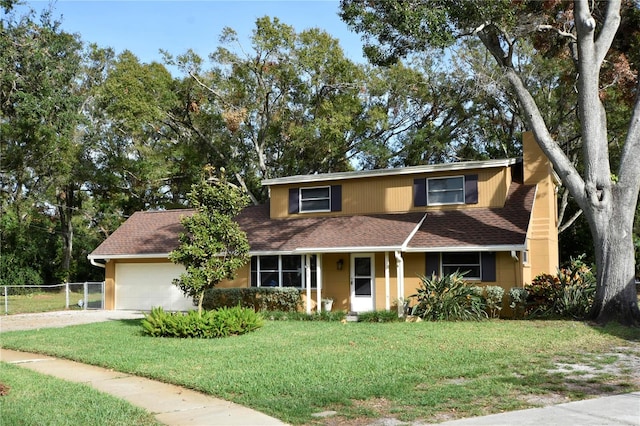 view of property with a front yard and a garage