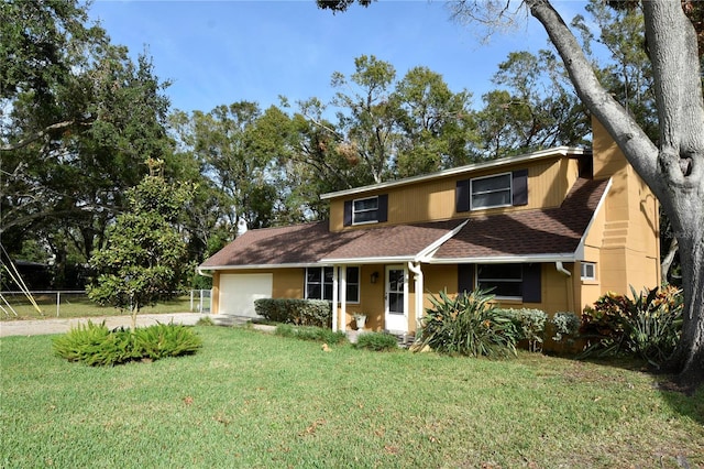 view of front of property with a garage and a front yard