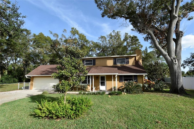 view of front of house featuring a front lawn and a garage