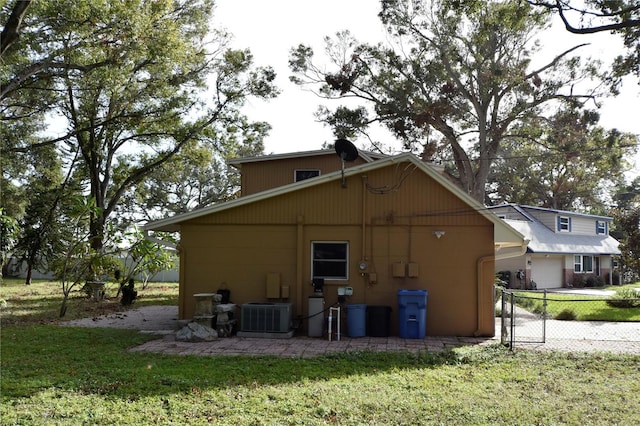 exterior space with a lawn and central AC