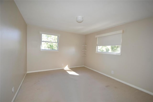 empty room with carpet floors and plenty of natural light