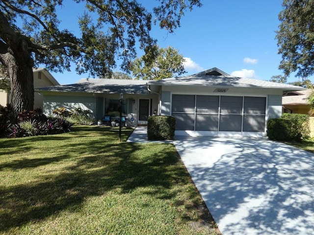 single story home featuring a front lawn and a garage