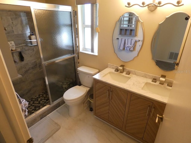 bathroom featuring toilet, walk in shower, and vanity