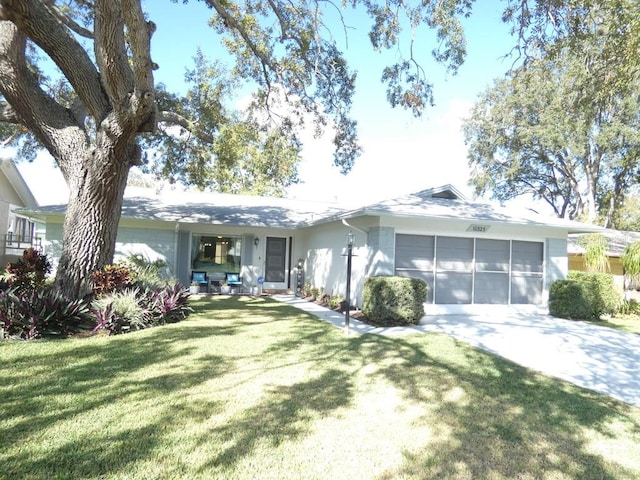 single story home featuring a front lawn and a garage